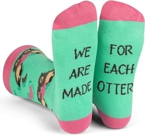 green socks with otters, they say "made for each other" on the sole