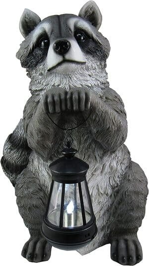 garden statue of raccoon holding LED light