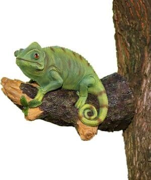 a sculpture of a chameleon sitting on a branch